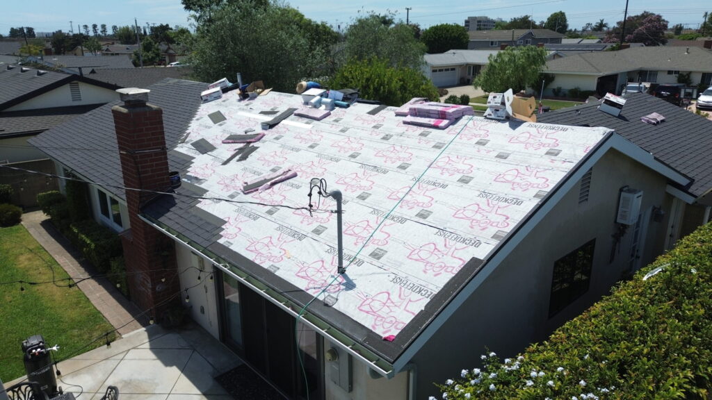 Aerial view of residential roof inspection and maintenance work in progress